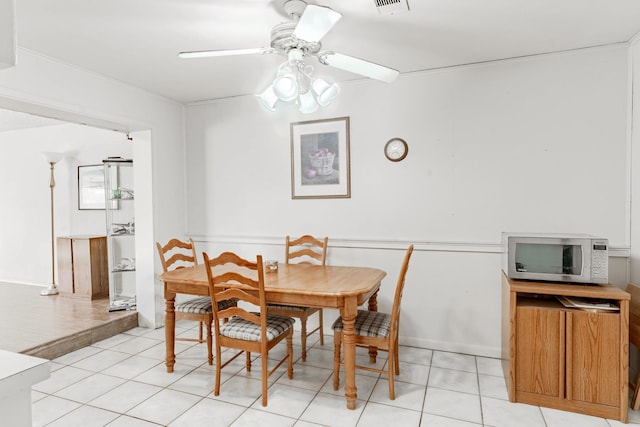 tiled dining area featuring ceiling fan