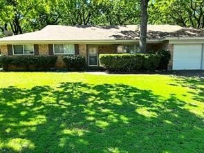 ranch-style home with a front yard and a garage