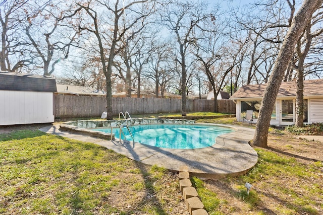 view of pool with a lawn, a storage unit, and a patio