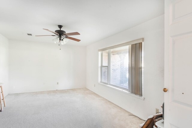 unfurnished room with ceiling fan and light colored carpet