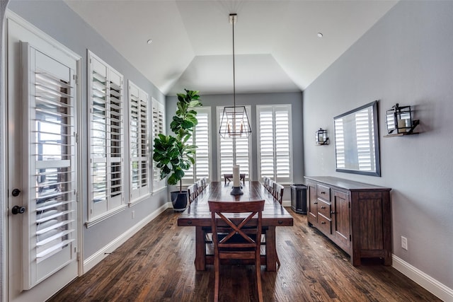 dining area with lofted ceiling and dark hardwood / wood-style flooring