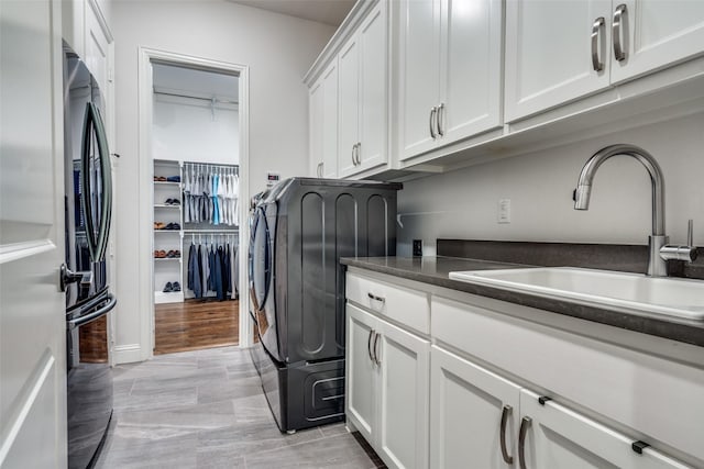 laundry area with cabinets and sink