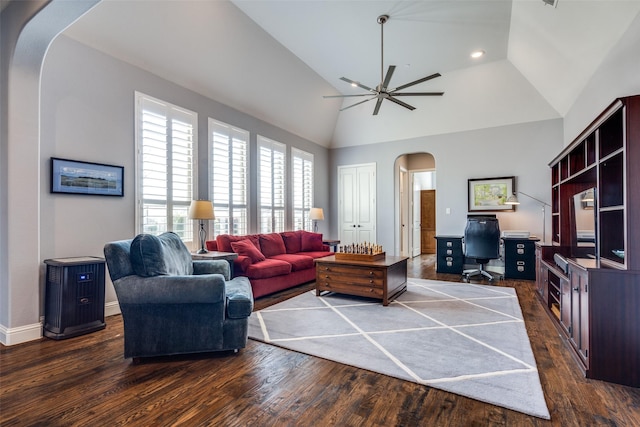 living room with ceiling fan, dark hardwood / wood-style flooring, and lofted ceiling