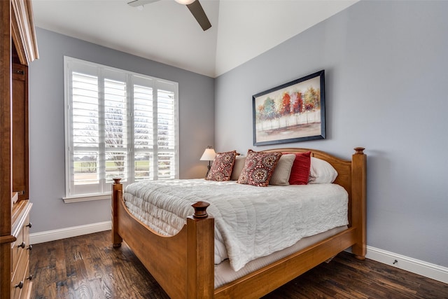 bedroom with vaulted ceiling, ceiling fan, dark hardwood / wood-style flooring, and multiple windows