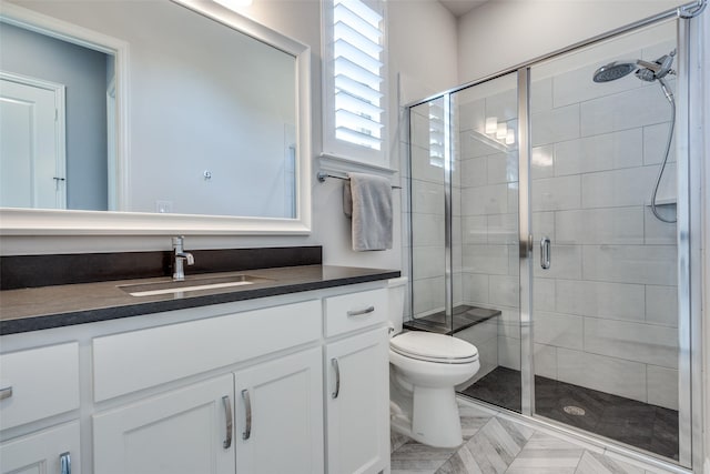 bathroom with vanity, toilet, and an enclosed shower