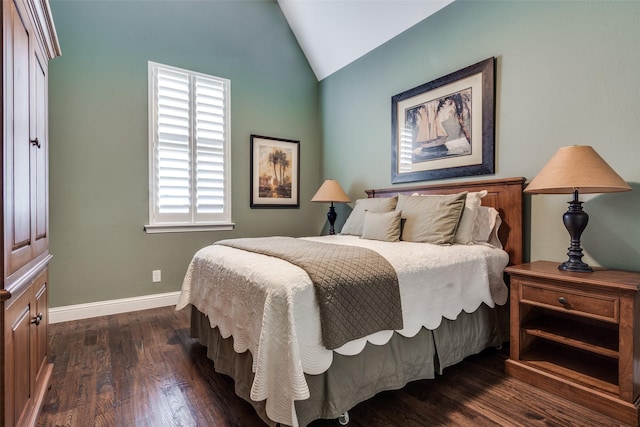 bedroom with vaulted ceiling and dark hardwood / wood-style flooring