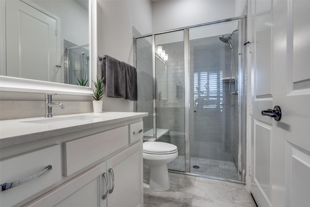 bathroom with a shower with door, toilet, and vanity