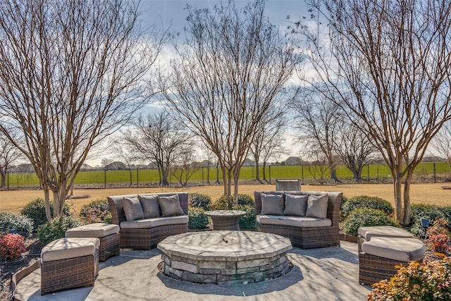 view of patio featuring a rural view and an outdoor living space with a fire pit