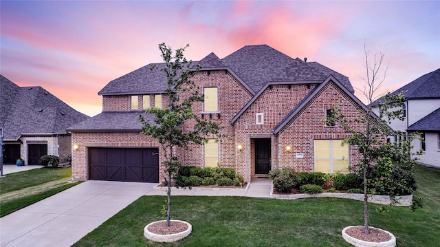 view of front of property with brick siding, driveway, a shingled roof, and a front lawn