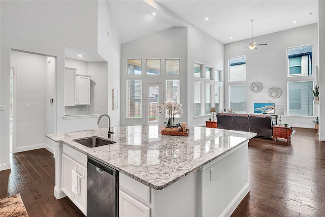 kitchen featuring a sink, high vaulted ceiling, ceiling fan, stainless steel dishwasher, and a center island with sink