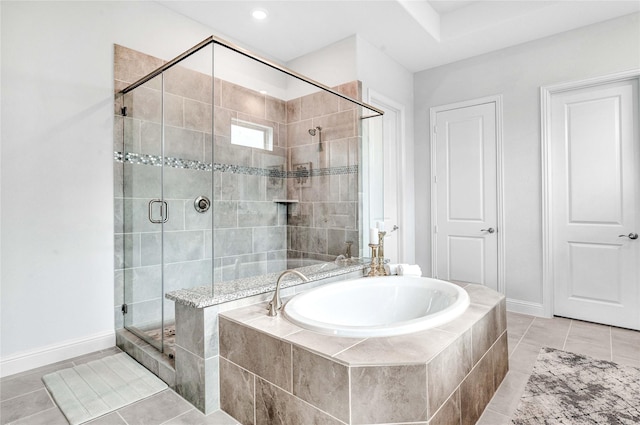 full bathroom with a garden tub, baseboards, a stall shower, and tile patterned floors