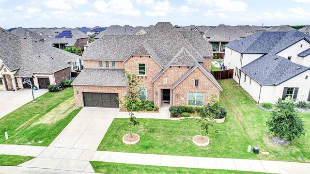 view of front of home with a yard and a garage