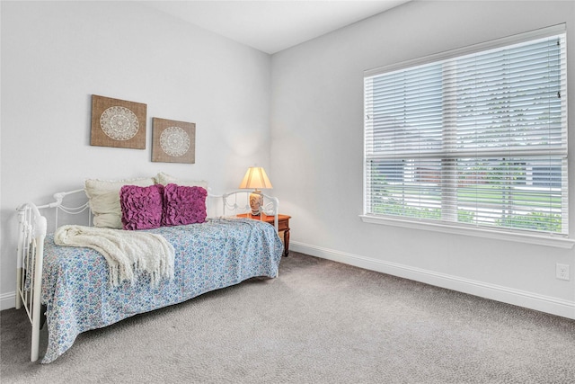 carpeted bedroom featuring baseboards