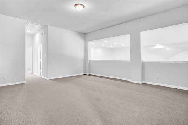 carpeted empty room featuring recessed lighting and baseboards