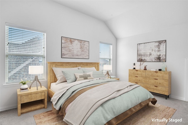 bedroom with lofted ceiling, carpet flooring, and baseboards