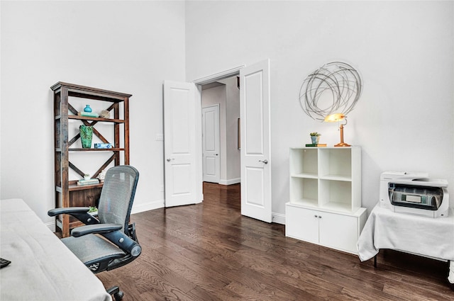 office with dark wood-style flooring and baseboards