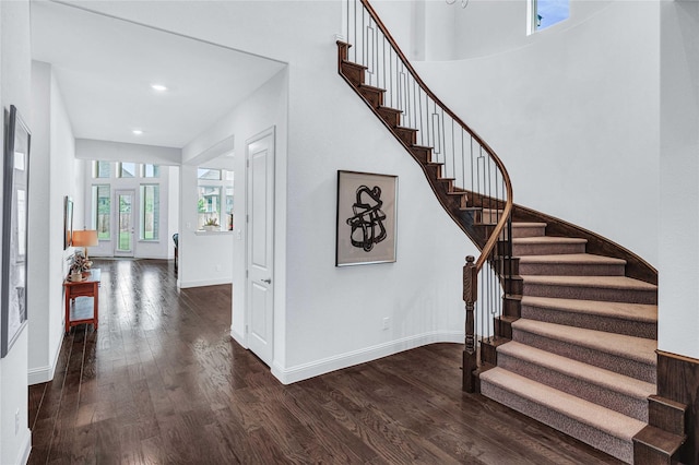 stairs featuring wood finished floors, baseboards, and recessed lighting