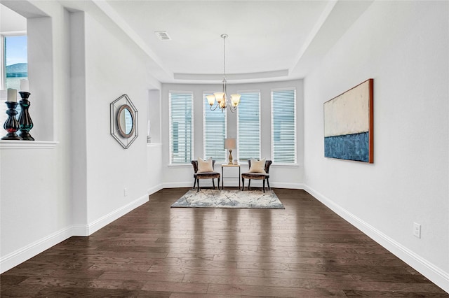 dining space with an inviting chandelier, baseboards, visible vents, and dark wood-type flooring