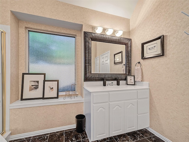 bathroom with walk in shower and vanity