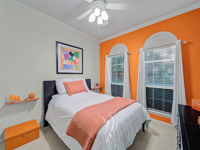 bedroom with ceiling fan, multiple windows, crown molding, and light carpet