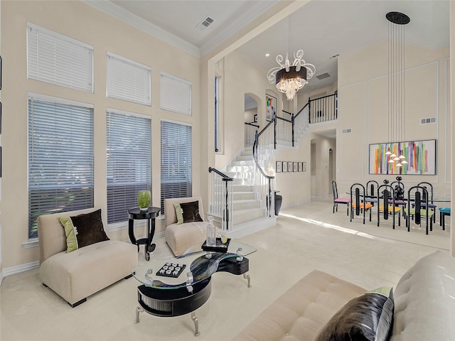 sitting room featuring a high ceiling, tile patterned flooring, crown molding, and an inviting chandelier