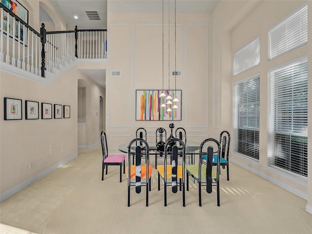 tiled dining room with a high ceiling