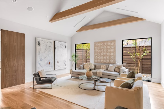 living room with light hardwood / wood-style flooring, high vaulted ceiling, and beamed ceiling