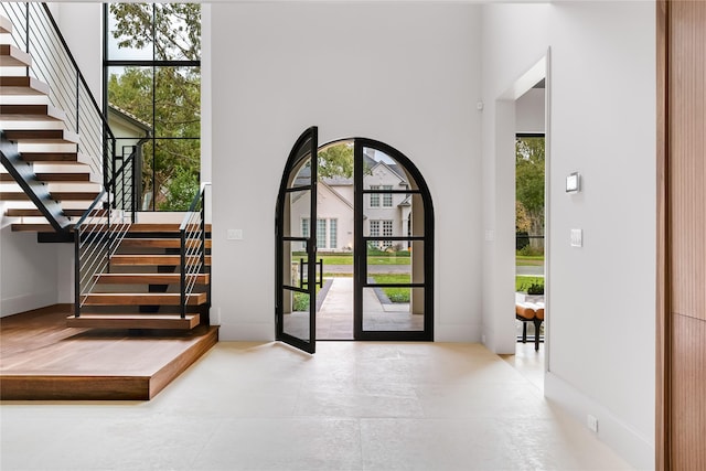 foyer featuring a towering ceiling