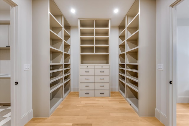 spacious closet with light hardwood / wood-style floors