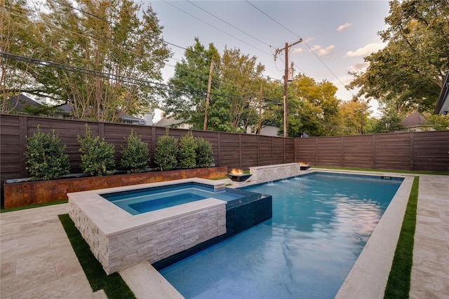 view of swimming pool featuring an in ground hot tub