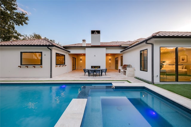 rear view of house featuring an outdoor kitchen and a patio