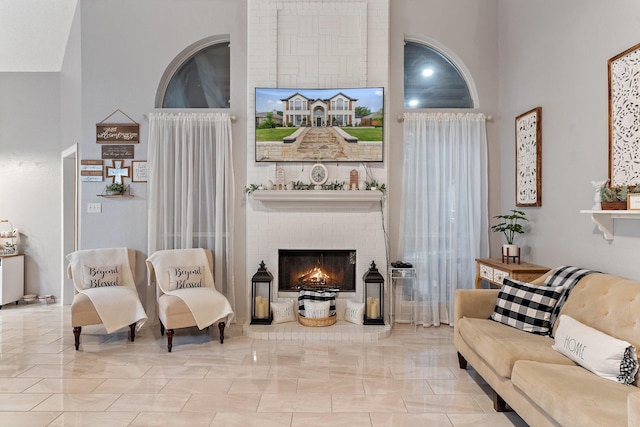 living room featuring a brick fireplace