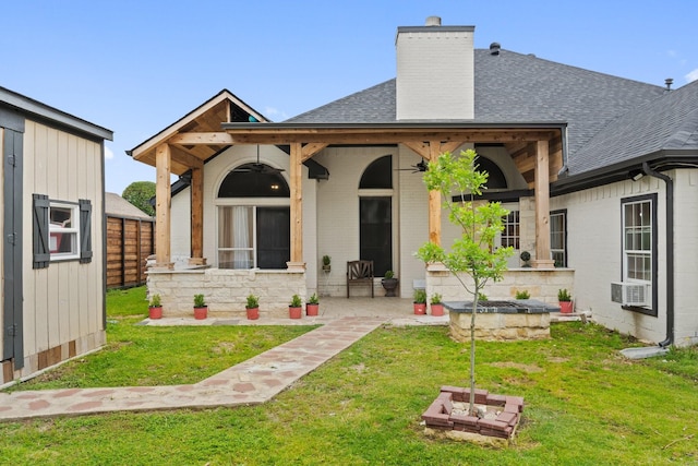 back of house featuring a patio area and a lawn