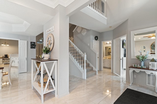 interior space featuring ceiling fan and crown molding