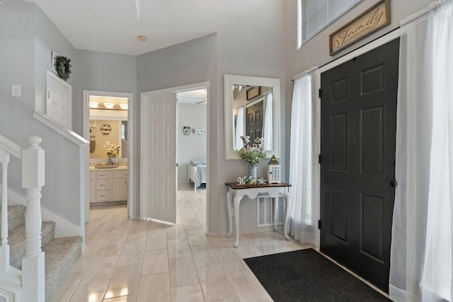 entrance foyer with ceiling fan