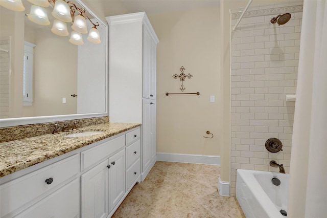 bathroom featuring tiled shower / bath and vanity