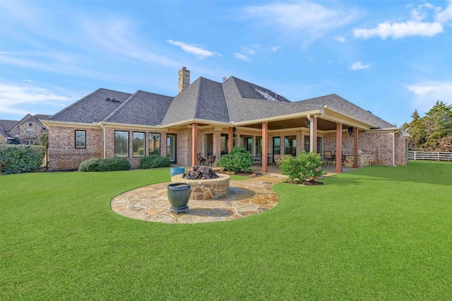 back of house with a patio area and a yard