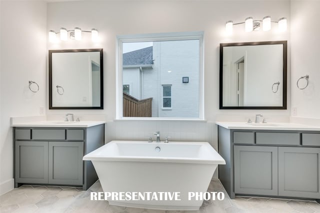 bathroom with vanity, tile patterned flooring, and a tub