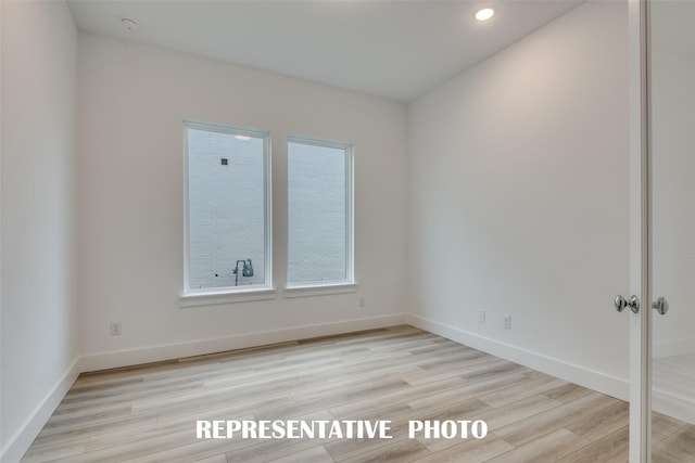 unfurnished room with light hardwood / wood-style flooring