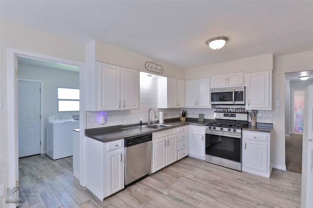 kitchen featuring sink, white cabinetry, appliances with stainless steel finishes, and light hardwood / wood-style flooring