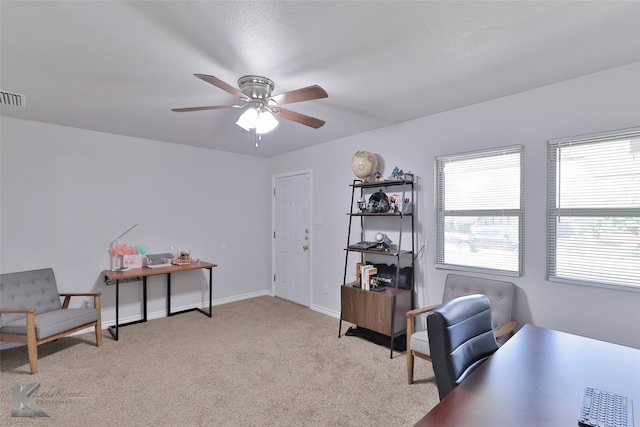 carpeted office space with ceiling fan