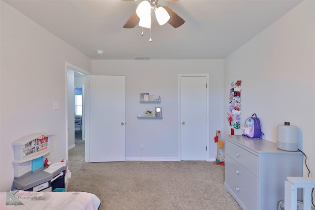 bedroom with ceiling fan and light carpet