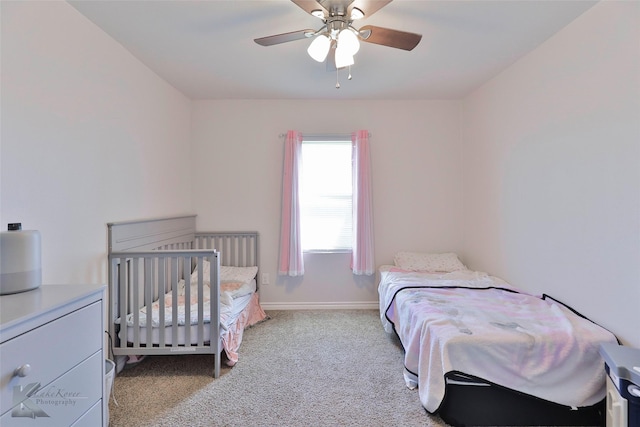 bedroom with light carpet and ceiling fan