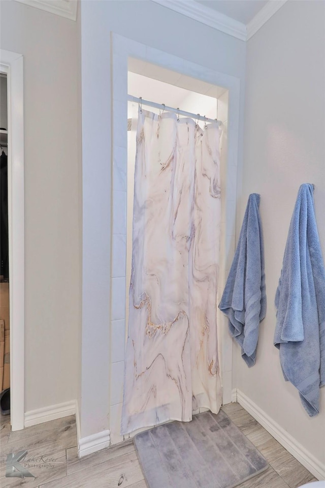 bathroom with crown molding and a shower with curtain