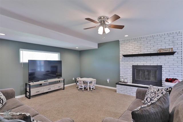 living room with ceiling fan, light carpet, and a fireplace