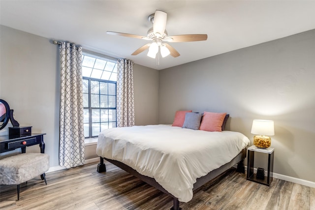 bedroom with ceiling fan and wood-type flooring