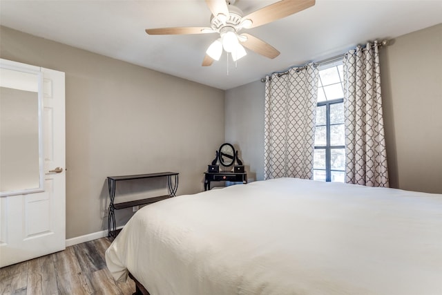 bedroom with ceiling fan and hardwood / wood-style floors