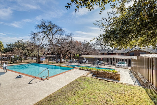 view of pool featuring a lawn and a patio