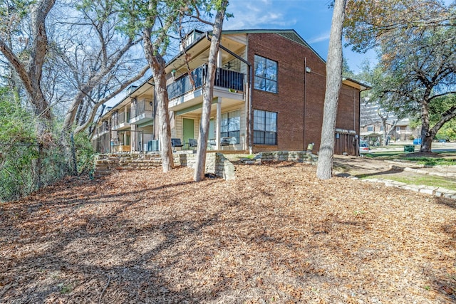 view of side of property with a balcony