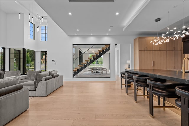 living room featuring sink and light wood-type flooring